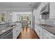Bright kitchen with granite counters and stainless steel appliances leads to dining area at 10822 Brandie Meadow Ln, Huntersville, NC 28078