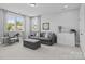 A cozy living room with a comfortable sofa, ottoman, and a view of the outdoors at 10822 Brandie Meadow Ln, Huntersville, NC 28078