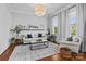 Bright living room with hardwood floors, white sofa with blue pillows, large windows and elegant decor at 10822 Brandie Meadow Ln, Huntersville, NC 28078