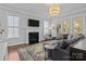 Bright living room featuring a fireplace, large windows, and a comfortable sectional sofa at 10822 Brandie Meadow Ln, Huntersville, NC 28078