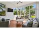 Relaxing screened porch featuring comfortable wicker furniture and a view of the outdoor fire pit at 10822 Brandie Meadow Ln, Huntersville, NC 28078