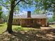 Rear exterior of a well-kept brick house with a chimney and backyard access at 1109 Reid Harkey Rd, Matthews, NC 28105