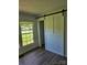 Bright bedroom featuring a sliding barn door and large windows with natural light at 1109 Reid Harkey Rd, Matthews, NC 28105