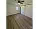 Bedroom with wood floors, natural light, and a sliding barn door to a closet at 1109 Reid Harkey Rd, Matthews, NC 28105