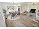 Bright open-concept living and dining area with modern lighting, fireplace, and stylish furniture at 1109 Reid Harkey Rd, Matthews, NC 28105