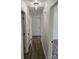 Well-lit hallway with neutral walls and wood-look flooring, connecting various rooms at 1109 Reid Harkey Rd, Matthews, NC 28105