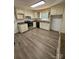 Open kitchen design featuring ample cabinet space and light-toned wooden flooring at 1109 Reid Harkey Rd, Matthews, NC 28105