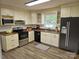 Bright kitchen featuring stainless steel appliances, light cabinets, and a window view at 1109 Reid Harkey Rd, Matthews, NC 28105