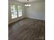 Inviting living room filled with natural light from large windows and laminate flooring at 1109 Reid Harkey Rd, Matthews, NC 28105