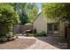 Charming backyard with brick patio, wooden bench, and landscaped garden area at 1160 Walton Pl, Salisbury, NC 28146