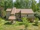 Back exterior showcasing a well-maintained lawn, covered patio, and mature trees for privacy at 1160 Walton Pl, Salisbury, NC 28146