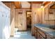 Bathroom features wood paneling, a blue tile floor, classic fixtures, and a separate shower area for a functional design at 1160 Walton Pl, Salisbury, NC 28146