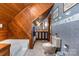 This bathroom features wood paneling, a bathtub, and a vanity with a sink, all contributing to a functional design at 1160 Walton Pl, Salisbury, NC 28146