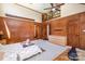 Bright bedroom features a tall ceiling, ladder to a loft, wood paneling, and neutral carpet for a comfortable retreat at 1160 Walton Pl, Salisbury, NC 28146