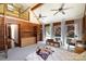 This bedroom features wood paneling, tall ceilings, windows, and a cozy loft area, creating a unique and inviting space at 1160 Walton Pl, Salisbury, NC 28146