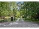 Gated driveway leading to property surrounded by dense woods at 1160 Walton Pl, Salisbury, NC 28146