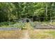 Exterior shot of the lush garden with raised beds and rows of green plants at 1160 Walton Pl, Salisbury, NC 28146