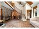 Open concept living room with brick floors, staircase, and view of the second story at 1160 Walton Pl, Salisbury, NC 28146