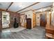 Living room with hardwood floors, wood burning stove, brick accent wall, and closet at 1160 Walton Pl, Salisbury, NC 28146