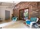 Relaxing covered patio with brick wall, wicker chairs, and ceiling fan at 1160 Walton Pl, Salisbury, NC 28146