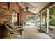 Bright sunroom with brick accent wall, wicker furniture, and views of the backyard at 1160 Walton Pl, Salisbury, NC 28146