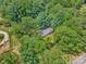 Idyllic property nestled among lush trees offers both privacy and a serene atmosphere, showcasing natural beauty at 13030 Mayes Rd, Huntersville, NC 28078