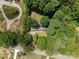 Aerial view of home situated amongst mature trees, with a circular driveway at 13030 Mayes Rd, Huntersville, NC 28078