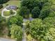 Aerial view of the home situated amongst mature trees, with a long driveway at 13030 Mayes Rd, Huntersville, NC 28078