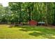 Spacious backyard features a fenced pen and chicken coop, with ample space and a storage shed at 13030 Mayes Rd, Huntersville, NC 28078