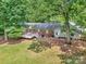 Backyard featuring a wooden deck, brick accents, and a verdant lawn, perfect for outdoor gatherings and relaxation at 13030 Mayes Rd, Huntersville, NC 28078