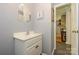 Cozy powder room with a single sink vanity and neutral wall color at 13030 Mayes Rd, Huntersville, NC 28078