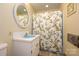 Small bathroom featuring a blue sink, patterned shower curtain, and an oval mirror at 13030 Mayes Rd, Huntersville, NC 28078
