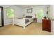 Calm bedroom featuring a white bed frame, two windows and matching bedside tables at 13030 Mayes Rd, Huntersville, NC 28078