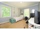 Bright bedroom with neutral walls, a white canopy bed, and a dedicated desk area at 13030 Mayes Rd, Huntersville, NC 28078
