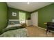 Cozy bedroom with green walls, a comfortable bed, and a window with a green view at 13030 Mayes Rd, Huntersville, NC 28078