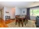 Dining room featuring hardwood floors and a large window with natural light at 13030 Mayes Rd, Huntersville, NC 28078