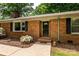 Close up of front door on brick home with black shutters and tidy landscaping at 13030 Mayes Rd, Huntersville, NC 28078