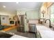 Kitchen view showing stainless steel appliances, a farmhouse sink, and granite countertops at 13030 Mayes Rd, Huntersville, NC 28078