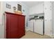 Bright laundry room with a washer, dryer, built in cabinets and decorative touches at 13030 Mayes Rd, Huntersville, NC 28078
