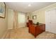 Home office with a cherry wood desk, leather chair, and natural light from the window at 13030 Mayes Rd, Huntersville, NC 28078