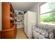 Well-organized pantry with wire shelving, a large refrigerator, and natural light from a window at 13030 Mayes Rd, Huntersville, NC 28078