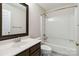 Bathroom with a single sink, dark wood vanity, and a shower/tub with white surround at 1308 Pennington Nw Pl, Concord, NC 28027