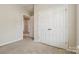 Bedroom with carpeting, view of closet and open door looking out to hallway at 1308 Pennington Nw Pl, Concord, NC 28027