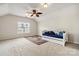Bedroom featuring vaulted ceilings, ceiling fan, and blue daybed over an area rug at 1308 Pennington Nw Pl, Concord, NC 28027