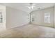Spacious carpeted bedroom with three windows providing natural light at 1308 Pennington Nw Pl, Concord, NC 28027