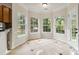 Bright breakfast nook surrounded by windows and tile floor at 1308 Pennington Nw Pl, Concord, NC 28027