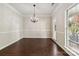 Formal dining room featuring crown molding, decorative chandelier, and hardwood flooring at 1308 Pennington Nw Pl, Concord, NC 28027