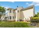 The home features neutral siding, a manicured lawn, and mature trees, creating a serene outdoor setting at 1308 Pennington Nw Pl, Concord, NC 28027