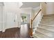 Welcoming foyer with wood-look tile floors and staircase with carpet at 1308 Pennington Nw Pl, Concord, NC 28027