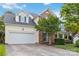 Charming two-story home with a well-manicured front yard and attached two-car garage at 1308 Pennington Nw Pl, Concord, NC 28027